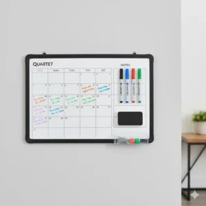 The quartet whiteboard calendar displayed with its included dry-erase marker, magnetic eraser, and mounting hardware.