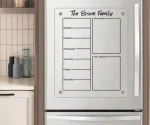 "Personalized family organizer style magnetic refrigerator calendar set up in a modern kitchen corner."